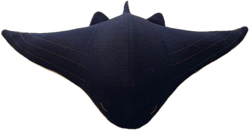 Cove, a navy manta-shaped weighted companion with copper stitch lines and softly spreading wings